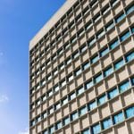 Close-up of office building and blue sky