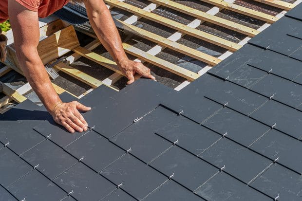 roofer installing slate shingles