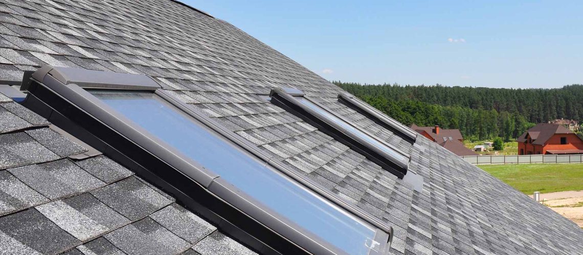 Roof windows and skylights and blue sky